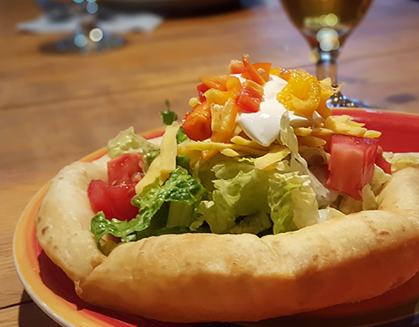 Taco salad served up on deep-fried flour tortilla.