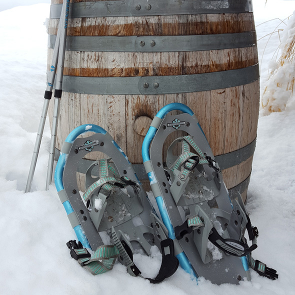 Snowshoes leaning against a barrel.