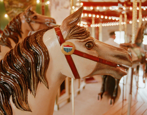 Restored, hand-carved palomino carousel horse.