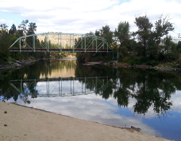 View of Kettle River from the Peggy Brixner Park's sandy beach. The historic Curlew Bridge is in the background.