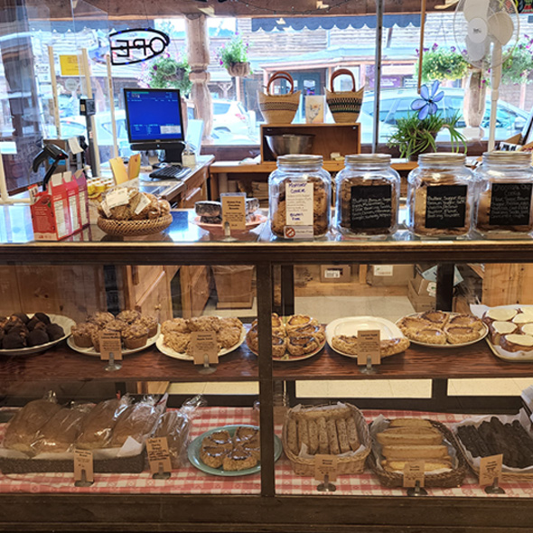 Display case of breads, cookies, cinnamon rolls, and more.