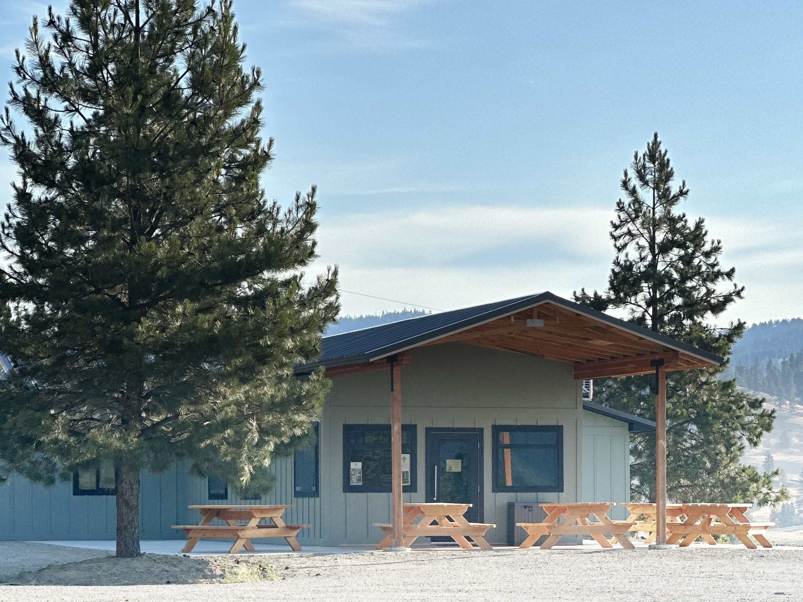 Trailside Good Eats and Gifts building and patio tables .